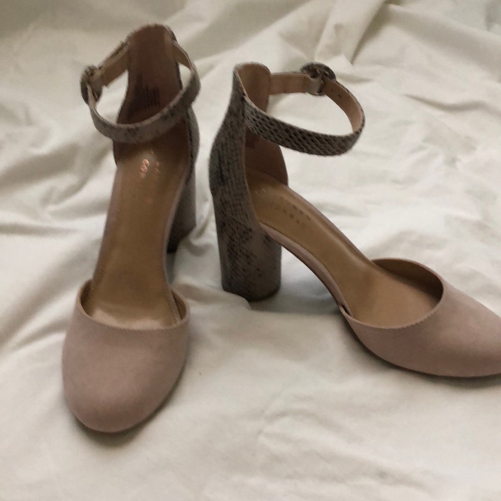 Dressy ankle strapped 3” chunky heel with snakeskin design and suede like toe.